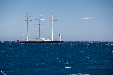 A huge sail yacht of conceptual design with three masts stands in the bay near Monaco at sunny day,...