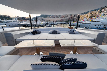The front deck of huge yacht in port of Monaco at sunset, the place for landing of helicopter, a lot...