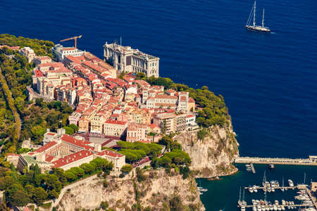 Aerial view of port Fontvieille at sunset, Oceanographic Museum of Monaco, South France, a lot of boats are moored in marina, view of city life from La Turbie mountain, mega yachts, luxury apartmentsの写真素材