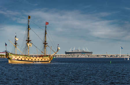 Russia, St. Petersburg, 20 May 2022: An ancient sailing frigate sails on the calm sea in sunset, the...