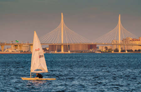 Russia, St. Petersburg, 20 May 2022: Sailing boats in the background of the new cable stayed bridge in sunset lightのeditorial素材