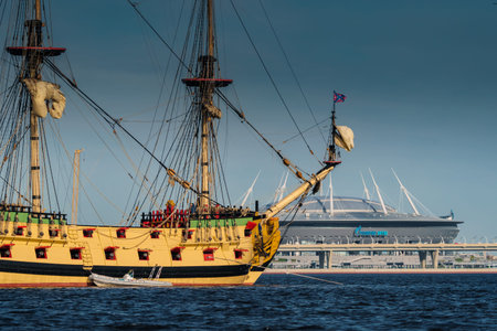Russia, St. Petersburg, 20 May 2022: An ancient sailing frigate sails on the calm sea in sunset, the...