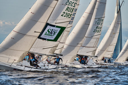 Russia, St.Petersburg, 10 June 2022: Teamwork in sailing regatta at sunset, skyscraper Lakhta center...