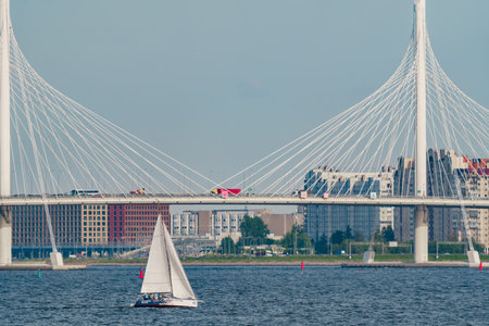 Russia, St. Petersburg, 10 June 2022: Sailing boats in the background of the new cable stayed bridge...