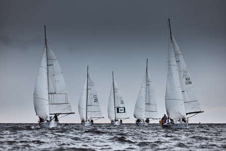 Russia, St.Petersburg, 17 June 2022: several sailing boats are on full course, a sailing race in stormy weather, teamwork in sailing regatta, the cloud skyのeditorial素材