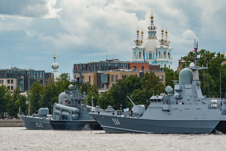 Russia, St. Petersburg, 28 July 2022: A several modern warships anchored at the Neva River embankment during the Navy Day celebrations in sunny weather, sailors on deck in festive uniformsのeditorial素材
