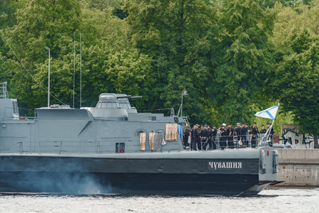 Russia, St. Petersburg, 28 July 2022: A several modern warships anchored at the Neva River embankment during the Navy Day celebrations in sunny weather, sailors on deck in festive uniformsのeditorial素材