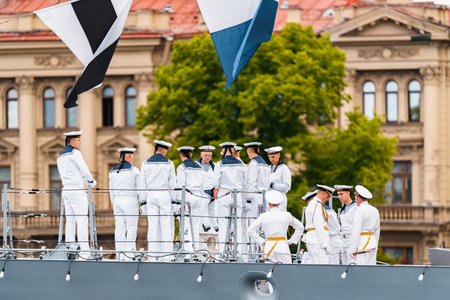 Russia, St. Petersburg, 31 July 2022: Military sailors dressed in festive uniforms take a group photo with the commander on the deck of a warship next to a huge cannon, the celebration the Navy Dayのeditorial素材
