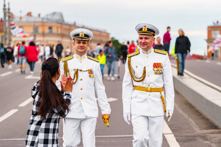 Russia, St. Petersburg, 31 July 2022: A lot of people at celebration of day of Navy on Blagoveshensky bridge, military sailor dressed in festive uniform, people want to be photographed with sailorsのeditorial素材