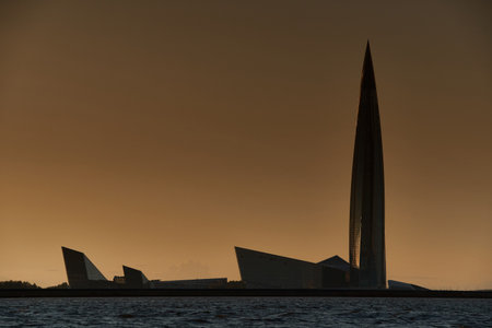 Russia, St.Petersburg, 07 July 2023: Highly building in Europe - skyscraper Lakhta center through sand coastline, gas and oil company Gazprom at sunset, facade of glass and ironのeditorial素材