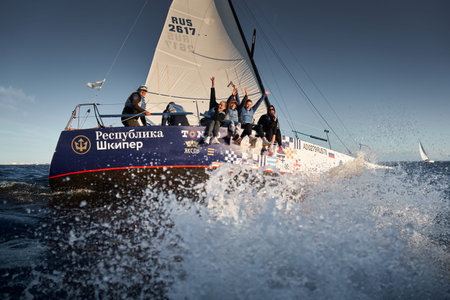 Russia, St.Petersburg, 07 July 2023: The view through the spray of how the sailboat is heeling at...
