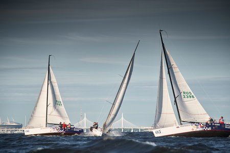 Russia, St.Petersburg, 07 July 2023: The sailing race, few boats in a roll go at high speed, sailing boats are in regatta at sunset, handsome sailors on the board of yacht, wind and splashesのeditorial素材