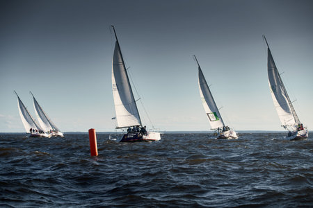 Russia, St.Petersburg, 07 July 2023: The sailing race, few boats in a roll go at high speed, sailing...