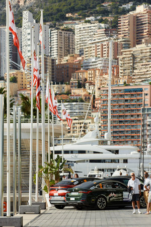 Monaco, Monte-Carlo, 29 September 2022: Exterior of new Yacht Club at sunny day, port Hercules, flagpoles, mega yachts and real estate on backgroundのeditorial素材