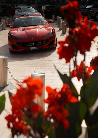 Monaco, Monte-Carlo, 22 October 2022: Square Casino Monte-Carlo at sunset, luxury cars, famous Hotel de Paris, wealth life, tourists take pictures of the landmark, pine trees, flowersのeditorial素材