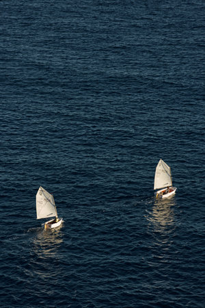 Monaco, Monte Carlo, 05 November 2022 - Two small sailing boats in sea at sunset, mediterranean lifestyleのeditorial素材