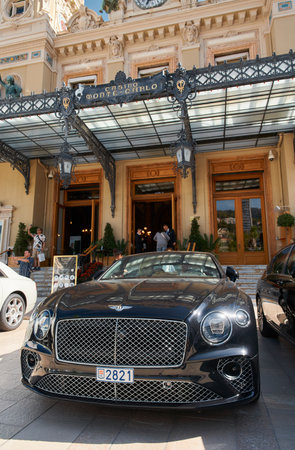 Monaco, Monte-Carlo, 29 September 2022 - Famous square Casino Monte-Carlo at sunny day, Bentley convertible, luxury cars, wealth life, tourists take pictures of the landmarkのeditorial素材