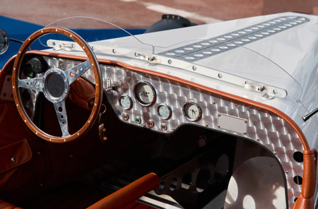 vintage open-top car at the yacht show in Monaco on a sunny day, leather seats, spoked wheels,...