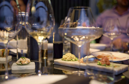 Champagne tasting, Wine glasses are on the table, stylish table setting, wine is poured from a...