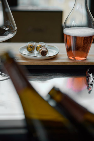 Decanter for sparkling wine on the table, Champagne tasting, Wine glasses, reflections, rose wineの写真素材