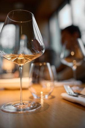 A glass of sparkling wine in close-up, Wine glasses are on the table, stylish table setting, sparkling wine bubblesの写真素材