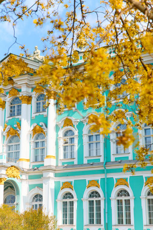 the incredibly picturesque facade of the Winter Palace through the branches of trees on a clear spring day, the heritage of Russia, the most famous landmark of St. Petersburg, the museumの写真素材