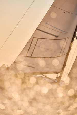 Sailing regatta in the Gulf of Finland at sunset, sailing yacht competing in a race, splashing water from under the boat, teamwork, board the boatの写真素材