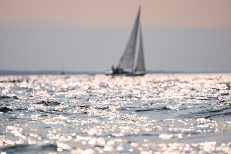 Sailing regatta in the Gulf of Finland at sunset, sailing yacht competing in a race, splashing water...
