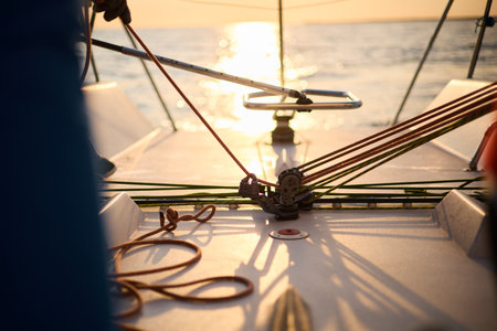 Sailing regatta in the Gulf of Finland at sunset, sailing yacht competing in a race, splashing water from under the boat, teamwork, board the boatの写真素材
