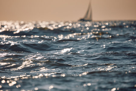 Sailing regatta in the Gulf of Finland at sunset, sailing yacht competing in a race, splashing water from under the boat, teamwork, board the boatの写真素材