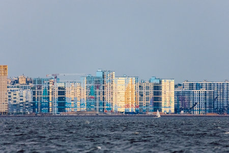 The residential complexes on the Gulf of Finland embankment on Vasilievsky island in sunset, bulk islands, sailing yachts, river navigationの写真素材