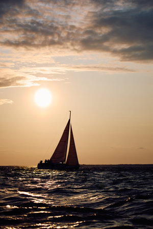 Sailing regatta in the Gulf of Finland at sunset, sailing yacht competing in a race, splashing water...