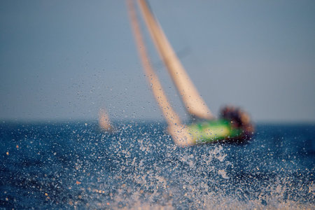 Sailing regatta in the Gulf of Finland at sunset, sailing yacht competing in a race, splashing water...