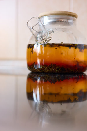 tea is brewed in a glass teapot, evaporation drops on the walls of the teapotの写真素材