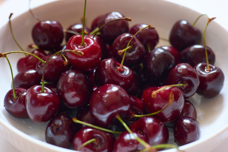 glass plate with ripe cherries close-up