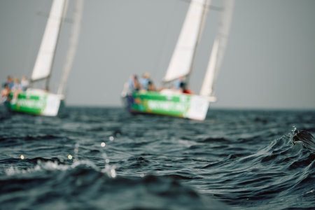 Sailing regatta in the Gulf of Finland, sailing yacht competing in a race, splashing water from under the boat, teamwork, board the boatの写真素材