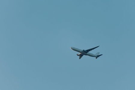 A passenger plane in the air against a blue sky background