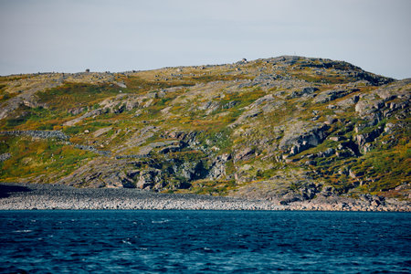 Round stones on the beach in Teriberka, the Barents Sea in the Murmansk region of northern Russiaの写真素材