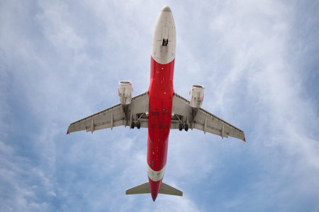 A huge passenger plane is landing in airport of Phuket, Thailand, a bottom view