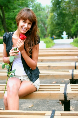 a girl holding a rose Budの写真素材