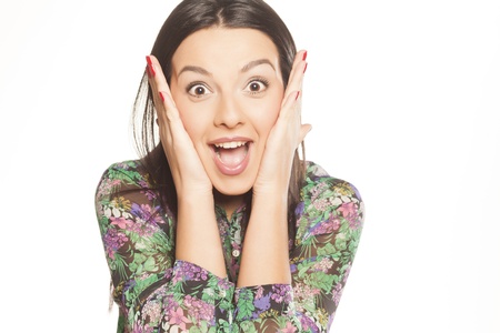 beautiful surprised brunette girl in colorful floral shirtの写真素材