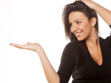 beautiful brunette in black blouse showing productの写真素材