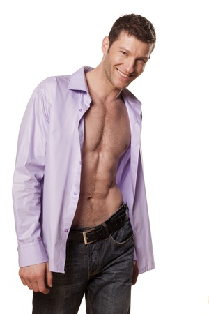 handsome athletic man with a smile and an open shirt on white backgroundの写真素材