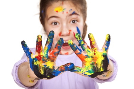 colors stained happy and smiling little girl showing ten fingers on white backgroundの写真素材
