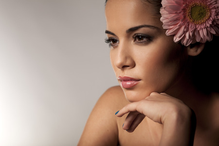 Portrait of a young beautiful woman with gerberaの写真素材