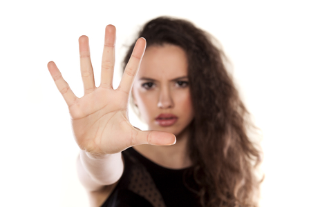 angry beautiful girl showing stop with her handの写真素材