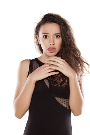 scared beautiful girl posing on a white backgroundの写真素材