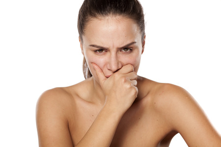 Young woman having a toothache on white backgroundの写真素材