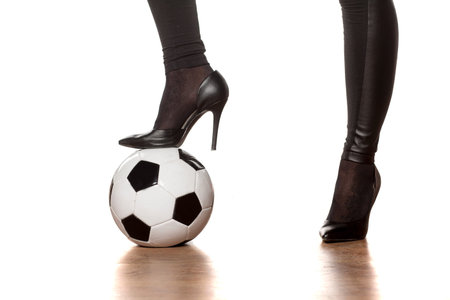 woman's legs in high heels and soccer ballの写真素材