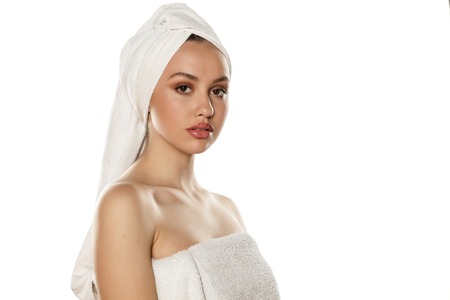 beautiful young woman with a towel on her headの写真素材